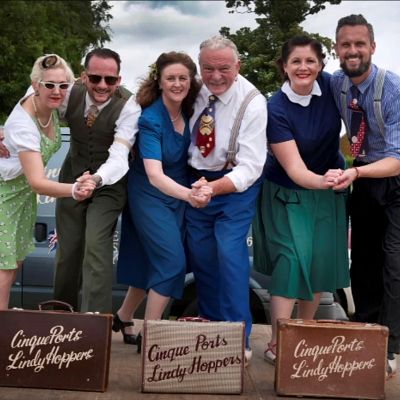 Cinque Ports Lindy Hoppers: Bodiam Senlac Classic Car show June 2018 - Posing on stage at the Car Show for the Hastings Observer (with special guest Lucky Lucie whilst Sugarfoot Sophie recovered from a dancing injury) - Photo by Frank Copper